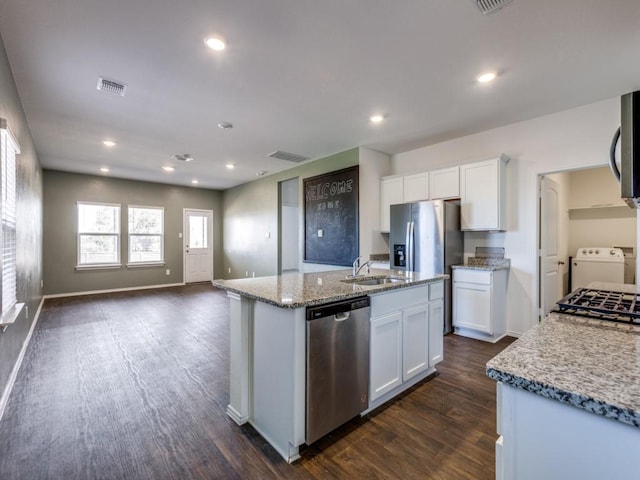 kitchen featuring dark hardwood / wood-style flooring, white cabinetry, stainless steel appliances, and a kitchen island with sink