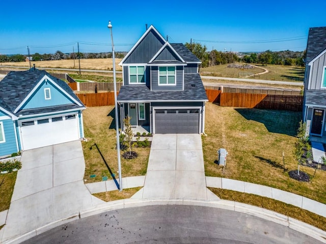 view of front of home with a front yard and a garage