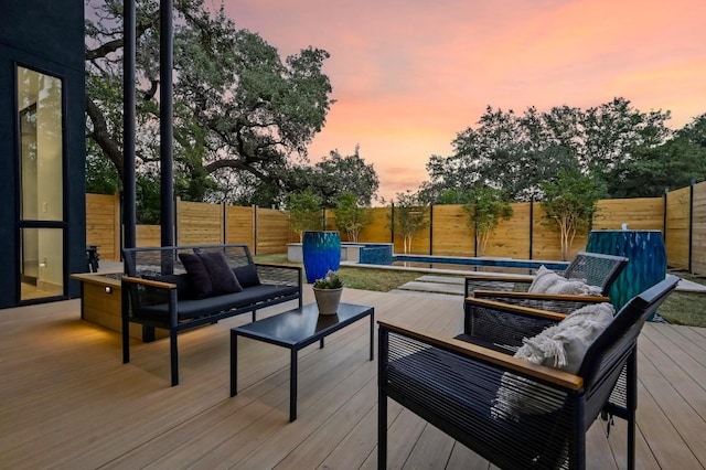 2423 S 5th St, Austin, TX 78704 - deck at dusk featuring an outdoor hangout area and a fenced backyard