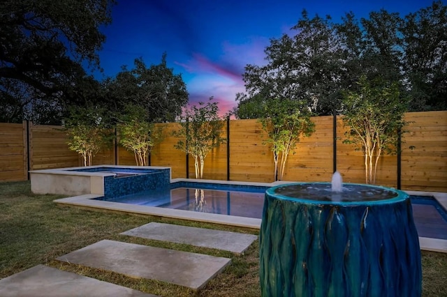 2423 S 5th St, Austin, TX 78704 - pool at dusk with a pool with connected hot tub and a fenced backyard