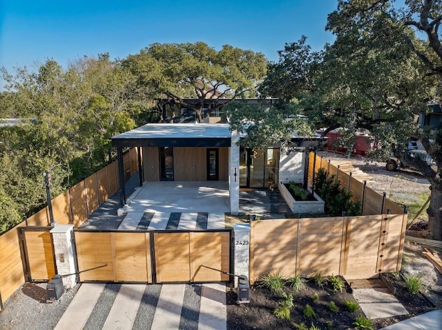 2423 S 5th St, Austin, TX 78704 - modern home featuring a fenced front yard and a gate