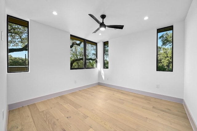 spare room featuring ceiling fan and light hardwood / wood-style floors