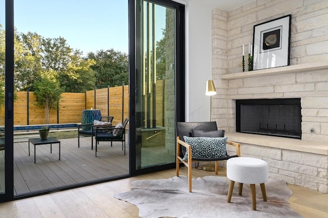 doorway to outside with hardwood / wood-style floors and an outdoor stone fireplace