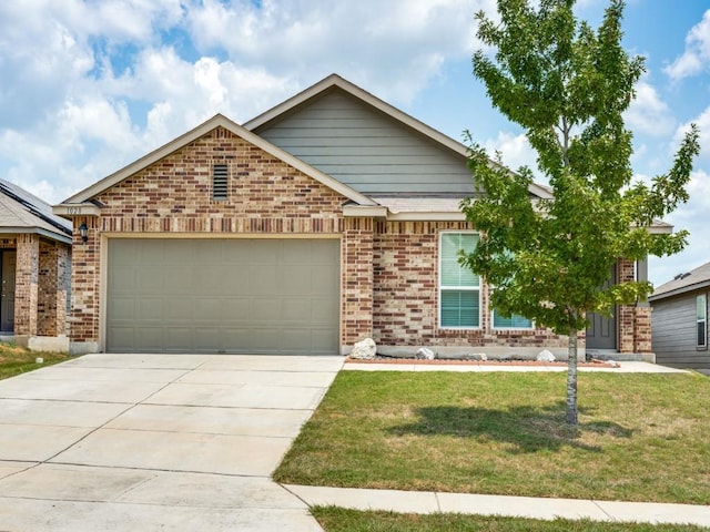 view of front of property featuring a front yard and a garage