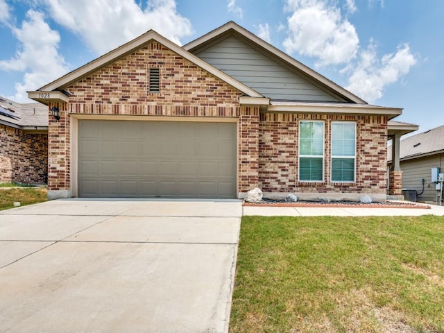 view of front of house with cooling unit, a garage, and a front yard