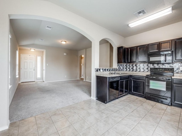 kitchen featuring light stone counters, light colored carpet, decorative backsplash, dark brown cabinets, and black appliances