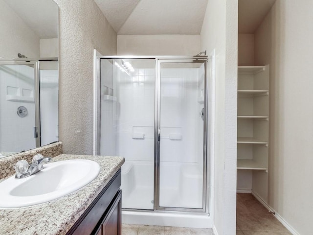 bathroom featuring vanity, tile patterned floors, and an enclosed shower