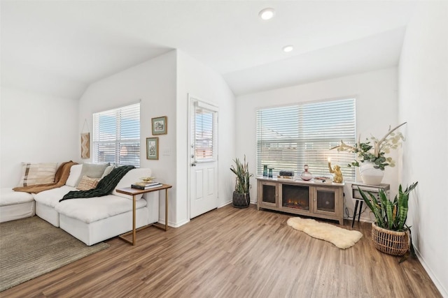 sitting room featuring lofted ceiling and light hardwood / wood-style flooring