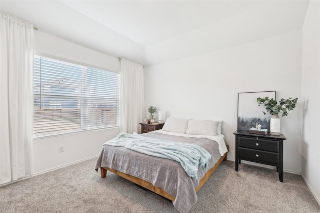 bedroom with lofted ceiling and carpet floors