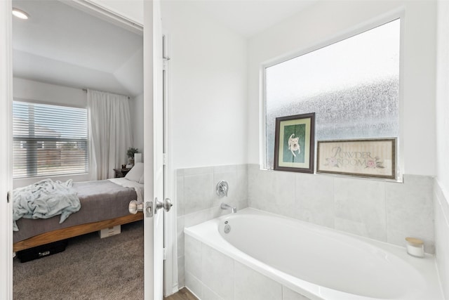 bathroom featuring tiled tub