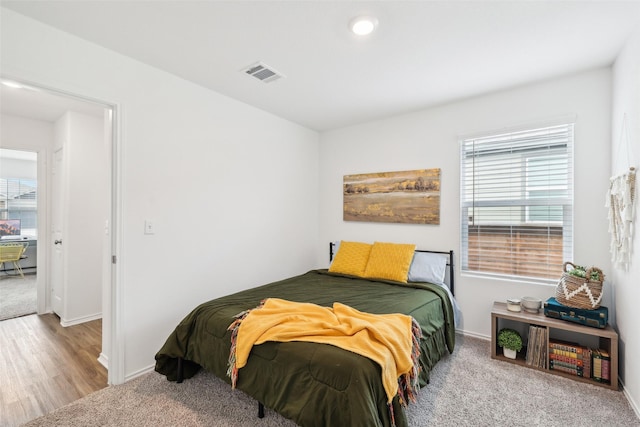 carpeted bedroom with multiple windows