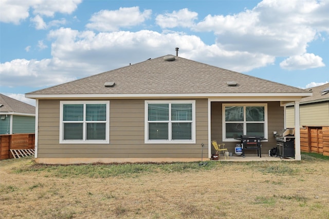 rear view of house featuring a yard and a patio area