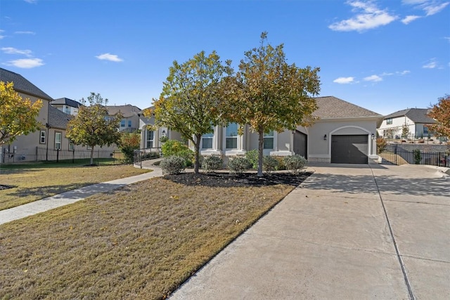 view of front of house with a garage and a front lawn