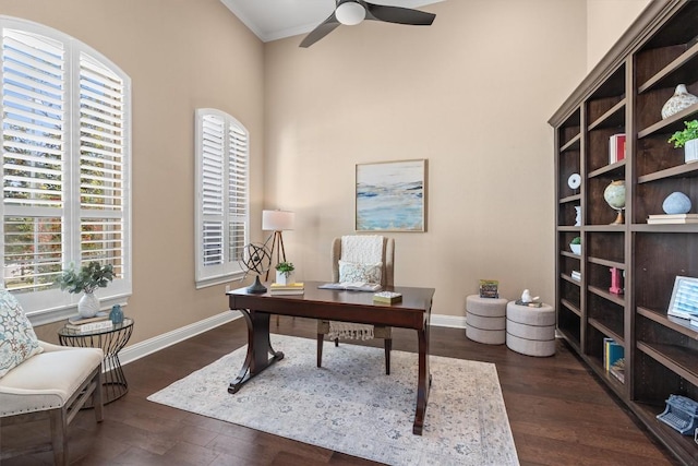 home office with ceiling fan, dark wood-type flooring, and ornamental molding