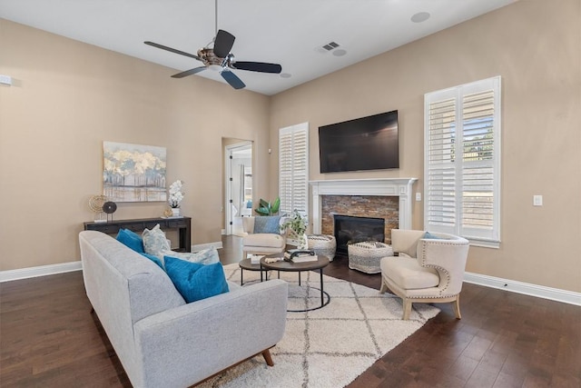 living room with ceiling fan, wood-type flooring, and a fireplace