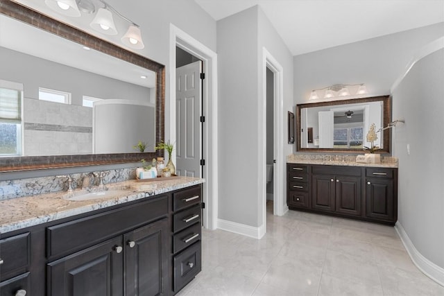 bathroom featuring toilet, tile patterned flooring, vanity, and walk in shower