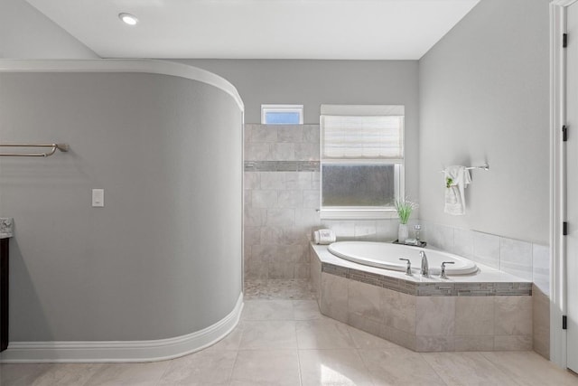 bathroom with tile patterned floors and tiled tub