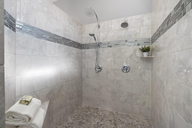 bathroom with a tile shower