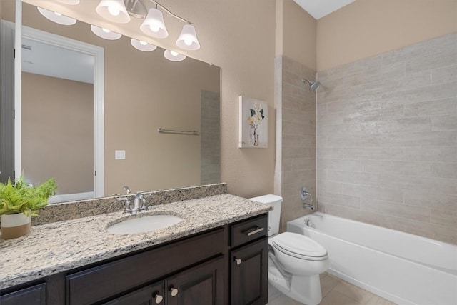 full bathroom with tile patterned floors, vanity, toilet, and tiled shower / bath combo