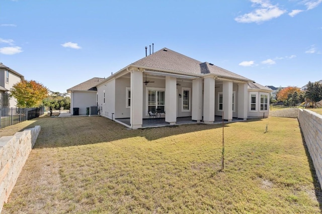 back of property featuring a lawn, ceiling fan, central AC unit, and a patio area