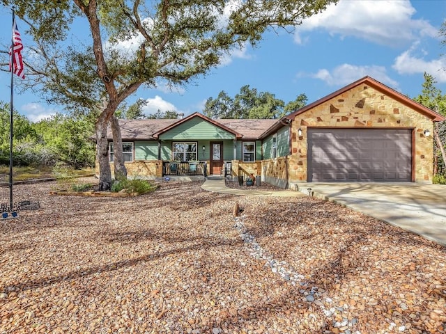 ranch-style home with a porch and a garage