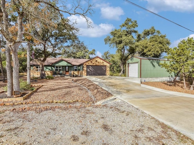 single story home with a garage and an outdoor structure