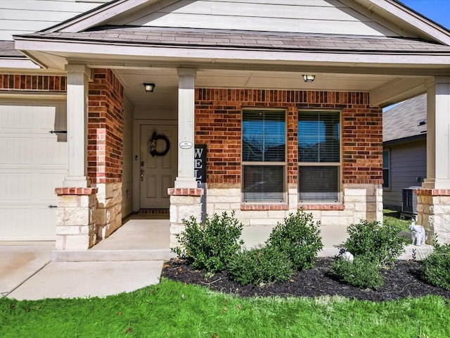 1640 T H Johnson Dr, Taylor, TX 76574 - view of exterior entry with brick siding, covered porch, and a garage