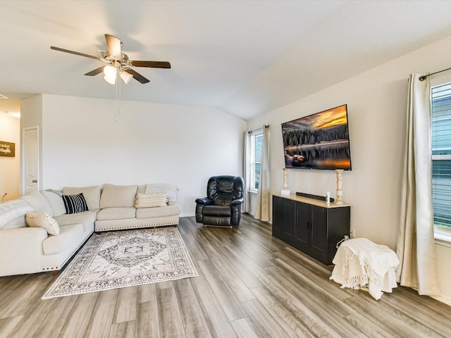 living area with lofted ceiling, ceiling fan, and wood finished floors