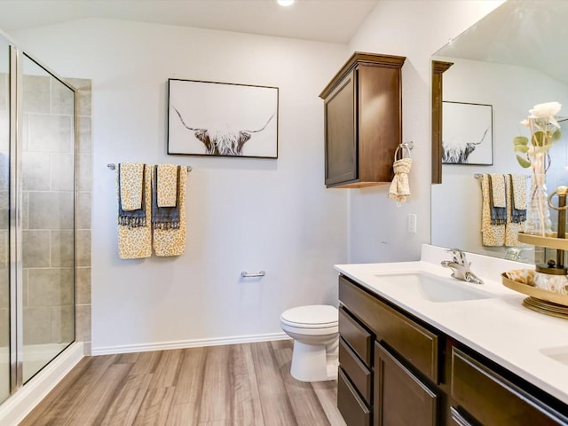 1640 T H Johnson Dr, Taylor, TX 76574 - bathroom with wood finished floors, a stall shower, double vanity, and vaulted ceiling