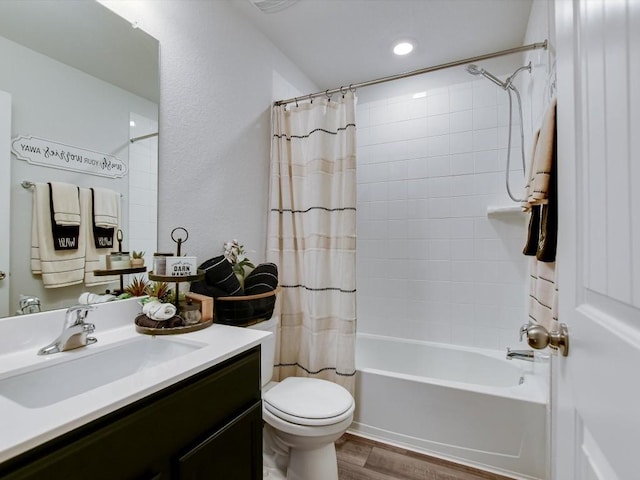 full bathroom with vanity, shower / bathtub combination with curtain, toilet, and wood finished floors