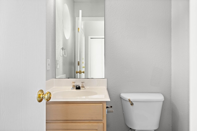 bathroom featuring toilet and vanity