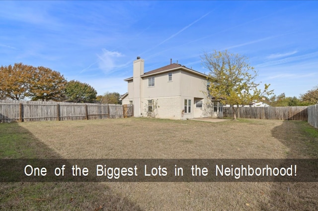 rear view of house with a lawn