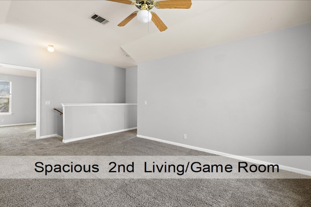 carpeted spare room with ceiling fan