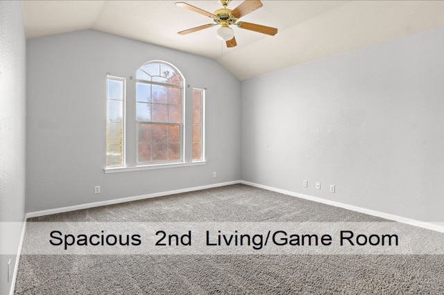 spare room featuring ceiling fan, lofted ceiling, and carpet floors