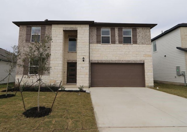 view of front of home with a front lawn and a garage