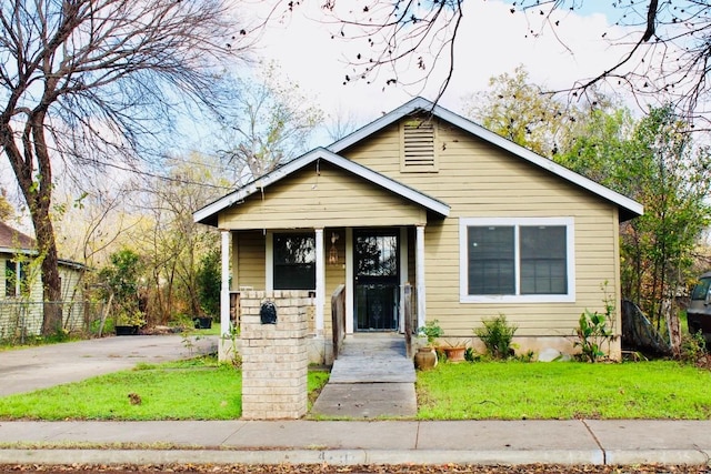 bungalow-style house featuring a front lawn