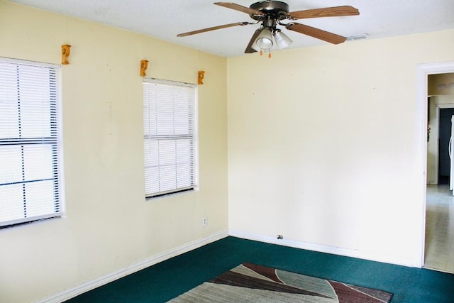 carpeted spare room featuring ceiling fan