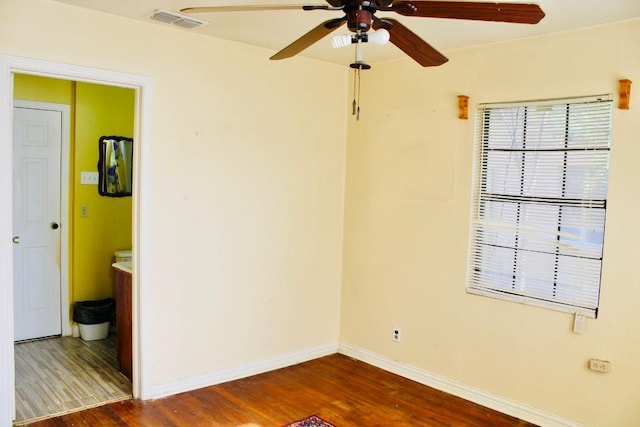 spare room with ceiling fan and dark hardwood / wood-style floors