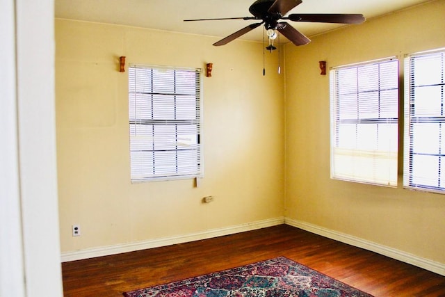 empty room with ceiling fan and dark hardwood / wood-style floors