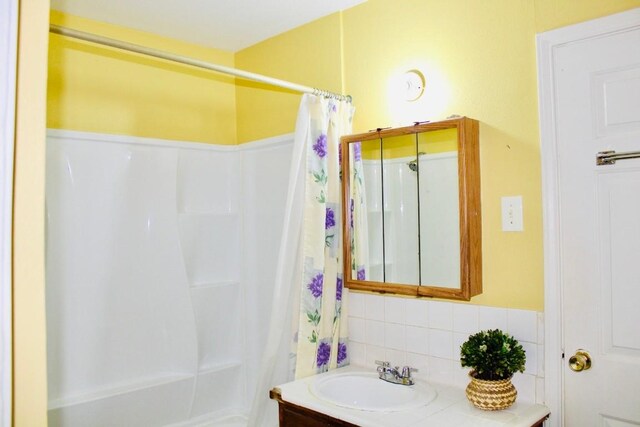 4704 Gonzales St, Austin, TX 78702 - bathroom featuring vanity and decorative backsplash