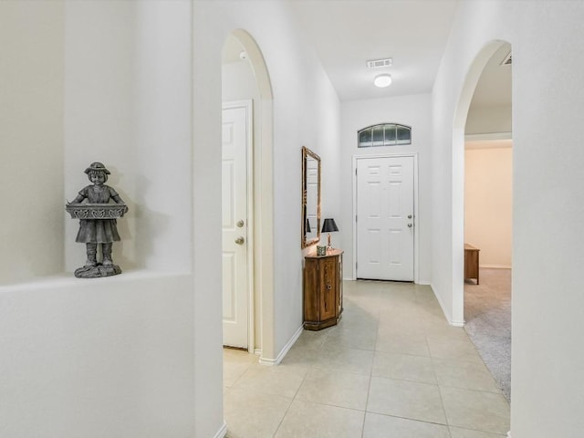 corridor featuring light tile patterned floors