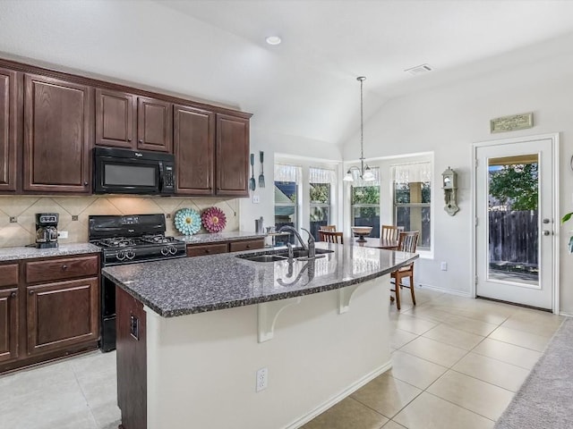 kitchen with black appliances, lofted ceiling, sink, and a kitchen island with sink