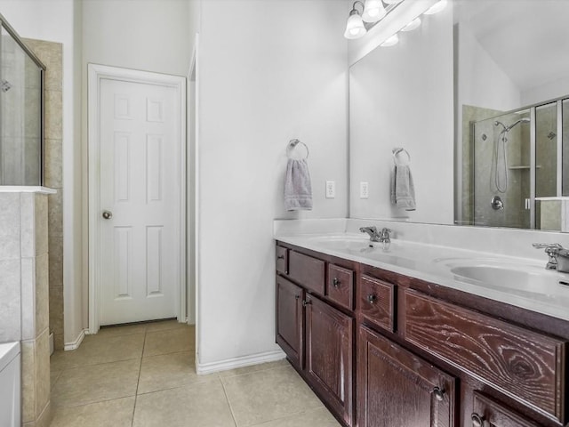 bathroom featuring tile patterned floors, vanity, and a shower with shower door