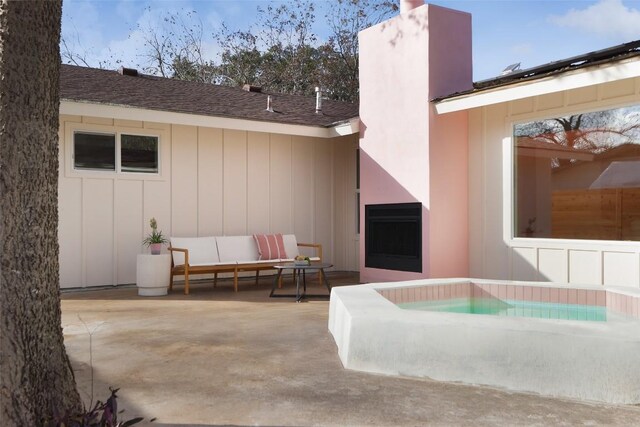 exterior space featuring outdoor lounge area, a hot tub, and a patio