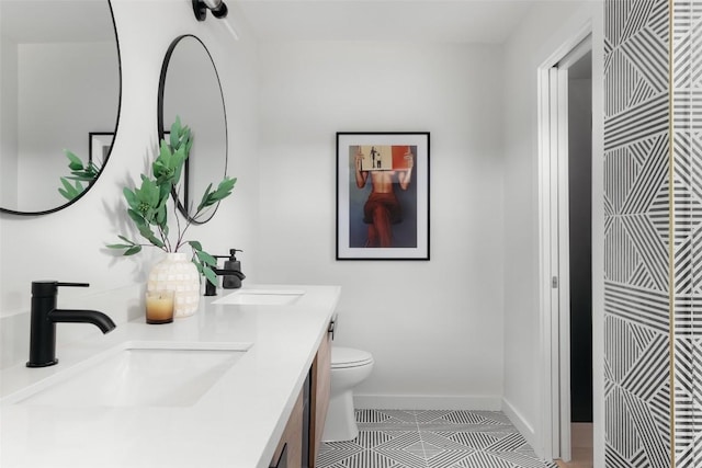 bathroom with vanity, toilet, and tile patterned flooring