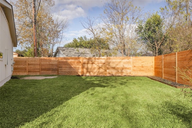 view of yard with a fenced backyard