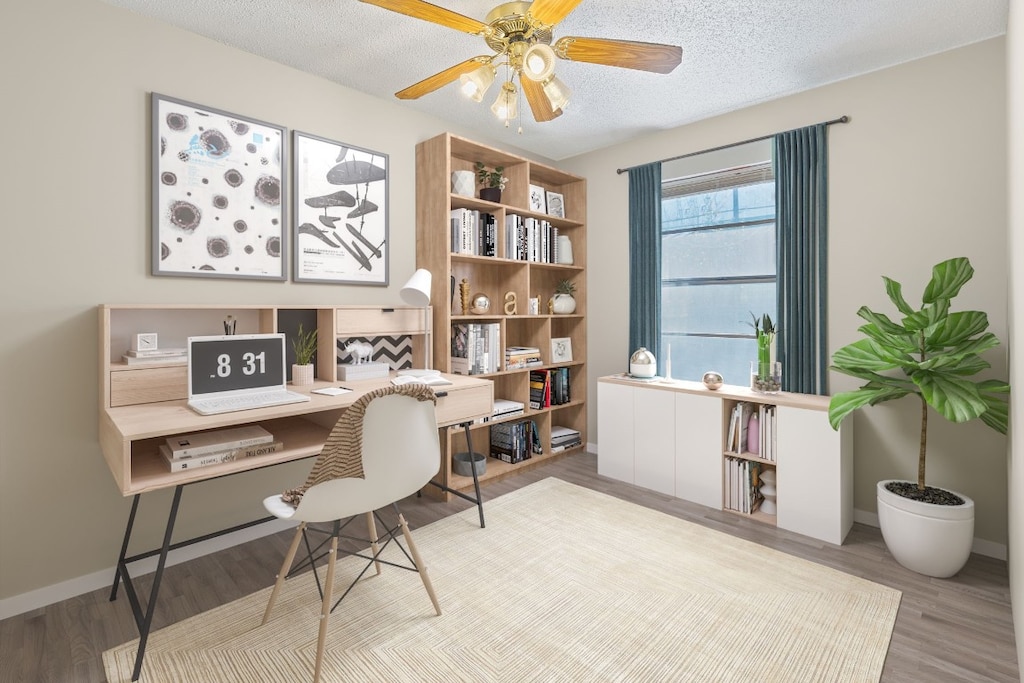 home office with ceiling fan, a textured ceiling, and light hardwood / wood-style flooring