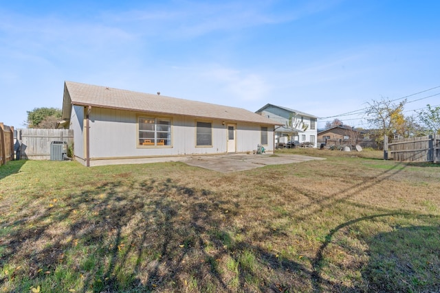 back of property featuring central AC, a patio area, and a lawn