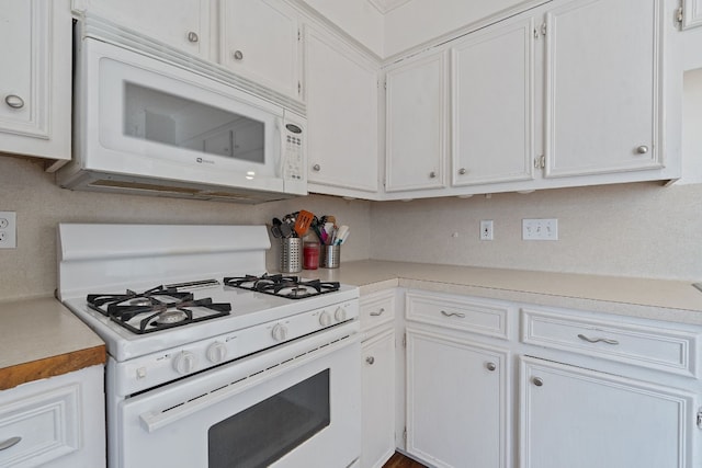 kitchen featuring backsplash, white cabinetry, and white appliances