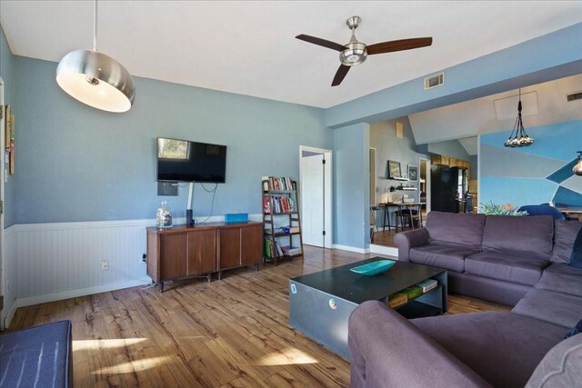 living room with hardwood / wood-style flooring and ceiling fan